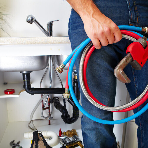 a plumber with various tools