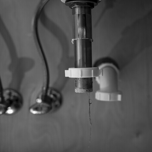 water dripping under a bathroom sink
